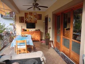 a patio with a table and a television on a balcony at Remig Ranch CIR 0001 in Challand Saint Victor