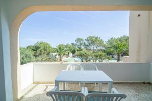 a blue table and chairs on a balcony at Morans-C in Es Pujols