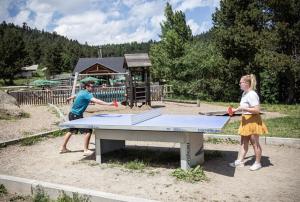 two children playing ping pong on a ping pong table at Huttopia Font Romeu in Font-Romeu +20 photos