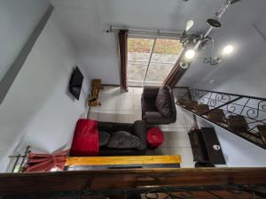 a living room with a couch and a staircase at Frangipani guesthouse in Hartbeespoort