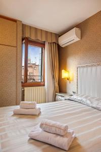 a bedroom with a bed with two towels on it at Hotel Castello in Venice +21 photos