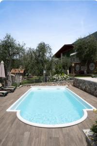 a swimming pool in a yard with a house at appartamenti ceccherini debora luna in Malcesine +18 photos
