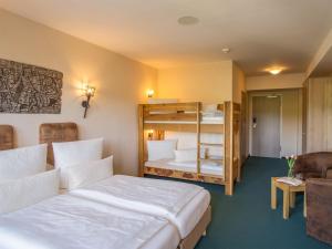 a hotel room with two beds and a bunk bed at Hasseröder Burghotel in Wernigerode