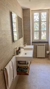 a bathroom with a white sink and a mirror at Residenza Castelnovo in Gubbio +33 photos
