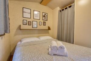 a bedroom with a bed with towels on it at Camping Miraflores in Rapallo +47 photos