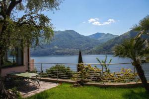 a house with a view of a lake and mountains at Il Tentione in Valsolda