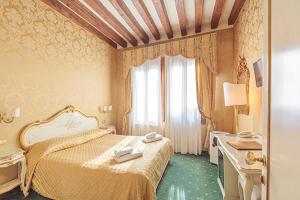 a hotel room with a bed and a window at Locanda Correr in Venice