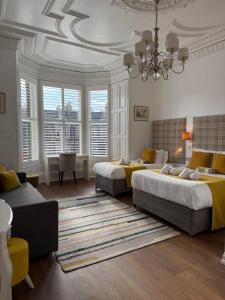 a bedroom with two beds and a chandelier at Edinburgh37 in Edinburgh