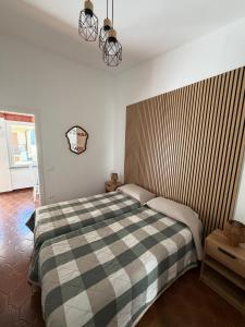 a bedroom with a bed with a checkered blanket at Terrazza in Manarola