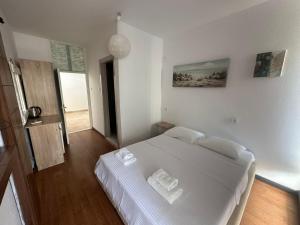 a bedroom with a large white bed in a room at Old Town Apart in Budva