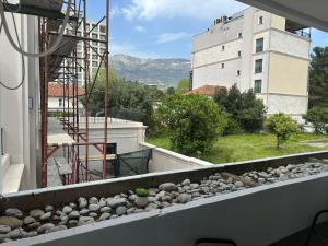 a balcony with rocks on the ledge of a building at Old Town Apart in Budva