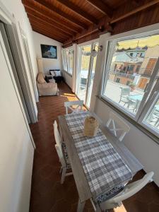 a dining room with a table and chairs and a couch at Terrazza in Manarola