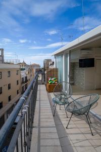 a patio with two chairs and a table on a balcony at Boemondo 33 in Bari