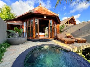 a villa with a pool in front of a house at Wanataru Sidemen Villas in Sidemen