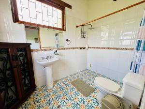 a bathroom with a toilet and a sink at Hacienda Campestre Oasis de la Villa in Villa de Leyva +19 photos