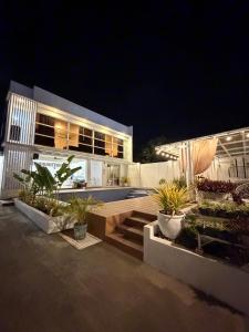 a house at night with plants in front of it at Sierra Monte Private Hot Spring Resort in Calamba