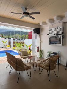 a living room with a table and chairs and a pool at Sierra Monte Private Hot Spring Resort in Calamba