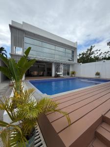 a house with a swimming pool in front of it at Sierra Monte Private Hot Spring Resort in Calamba