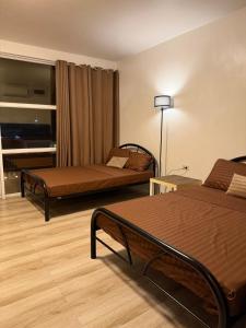 a hotel room with two beds in a room at Sierra Monte Private Hot Spring Resort in Calamba +19 photos