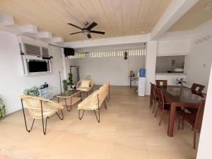 a living room with a ceiling fan and a table and chairs at Sierra Monte Private Hot Spring Resort in Calamba