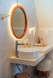 a bathroom with a sink and a mirror at Svargan Lakeside Glamping in Tabanan +56 photos