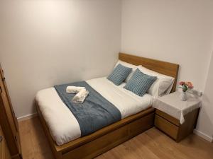 a bedroom with a bed with two towels on it at Hidden Gem in Foots Cray