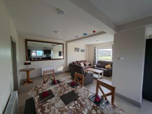 a living room with a couch and a table at Tigh Fitz Apartments - Inis Mór, Aran Island in Inis Mor