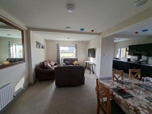 a living room with a couch and a table at Tigh Fitz Apartments - Inis Mór, Aran Island in Inis Mor