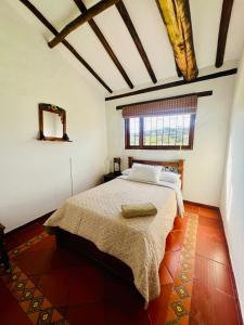 a bedroom with a large bed in a room at Hacienda Campestre Oasis de la Villa in Villa de Leyva