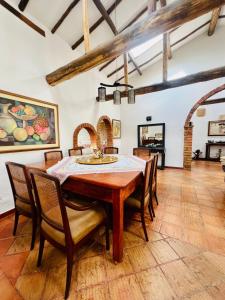 a dining room with a wooden table and chairs at Hacienda Campestre Oasis de la Villa in Villa de Leyva