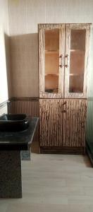 a bathroom with a wooden door and a window at Rivana Inn - ريفانا in ‘Izbat an Nāmūs +5 photos