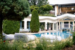 a house with a swimming pool in front of it at Sendlhofer's in Bad Hofgastein