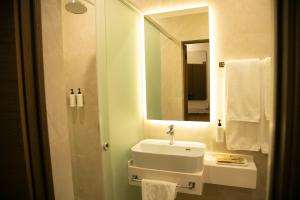 a bathroom with a sink and a mirror at Aristocrat Hotel in Kapchagay
