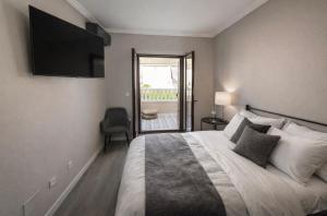 a bedroom with a bed with a television on the wall at Casa Claudia&Simon in Santa Pola