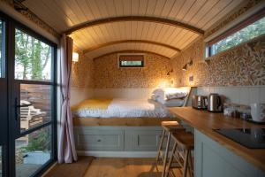 a bedroom in a tiny house with a bed at The Carriage in Kenton