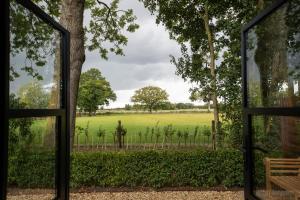 a view of a field through a glass door at The Carriage in Kenton