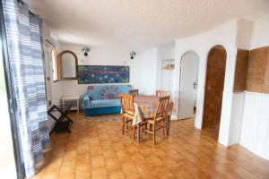 a living room with a table and chairs and a bed at Il Villaggio Del Mago in Lampedusa