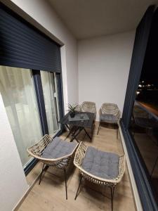 a balcony with chairs and a table on a building at Silver Marina Residence in Veliko Gradište
