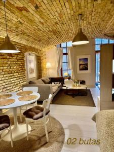 a living room with a couch and a table at Six Apartment Simona in Vilnius