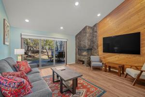a living room with a couch and a tv at 4 Quelah Condo in Sunriver