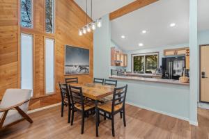 a dining room with a table and chairs and a kitchen at 4 Quelah Condo in Sunriver