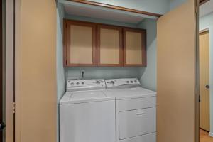 a kitchen with a white stove and a washer at 4 Quelah Condo in Sunriver +18 photos