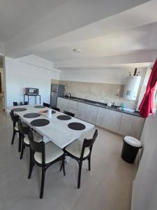 a room with a table and chairs in a kitchen at Departamento Alberdi in San Pedro de Jujuy +20 photos