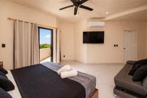 a bedroom with a bed and a tv and a couch at CISNE Luxury House in Xetna +46 photos