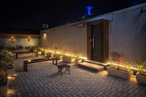 a patio with benches and lights at night at Casa Container Mirante do Cristo in Foz do Iguaçu