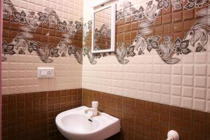 a bathroom with a sink and a mirror at Lakeside Room stay in Yelagiri