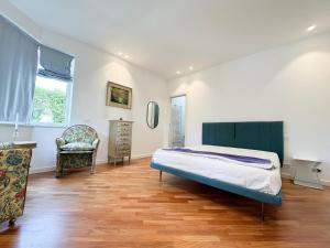 a bedroom with a bed and a desk and a chair at Mondello Luxury villa in Palermo