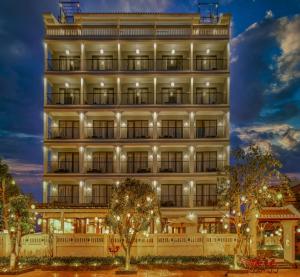 a tall white building with lights on at Savvy in Hoi An - The Essence of Refined Retreat in Hoi An