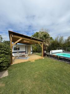 a backyard with a pavilion and a swimming pool at Caravane Chic et Vintage in Urrugne