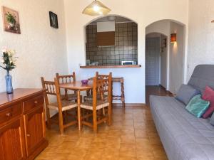 a living room with a table and chairs and a couch at Basic Comfort Studio Poblat tipic 0168 in Empuriabrava +17 photos